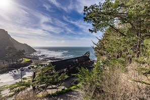 A coastal building with a view of the ocean and cliffs.