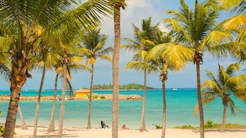 On the beach, white sand, sun-loungers, beach umbrellas