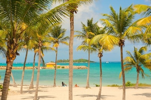 On the beach, white sand, sun loungers, beach umbrellas
