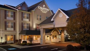 A Country Inn & Suites building with a prominent sign, multiple entry points, and a parking area. - Country Inn & Suites by Radisson, Frackville (Pottsville), PA (Pottsville)
