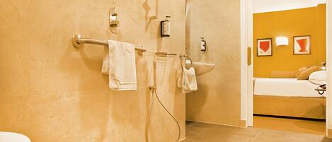 A bathroom with a shower, toilet, and sink.