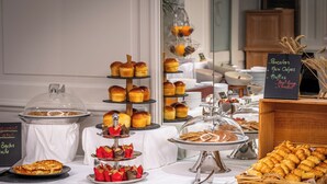 A buffet table with various baked goods and pastries, including mini crepes, muffins, and croissants. - Domaine du Limonay, The Originals Collection (Saint-Meloir-des-Ondes)