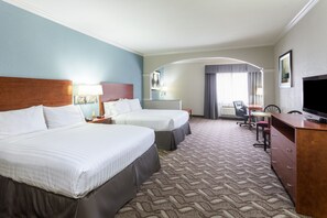 A hotel room with two beds, a desk, a television, and a bathroom visible through an arched doorway. - Holiday Inn Express Hotel & Suites Lake Charles by IHG (Lake Charles)