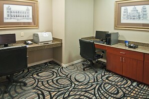 A hotel office space with two desks, computers, chairs, a printer, and framed pictures on the wall. - Holiday Inn Express Hotel & Suites Lake Charles by IHG (Lake Charles)