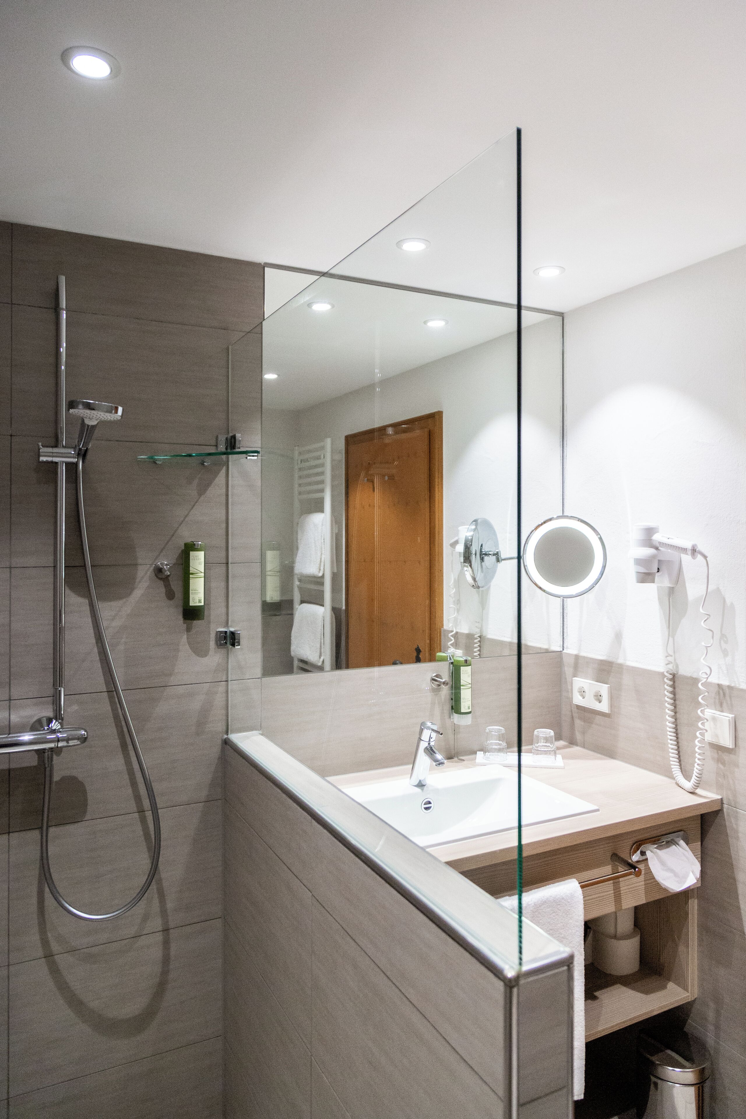 superior double room | bathroom | shower, eco-friendly toiletries, hair dryer, towels