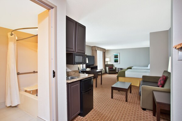 A compact hotel room with a kitchenette, a shower, a bed, and a small seating area. - Holiday Inn Express Hotel & Suites Harrington-Dover area, DE by IHG (Harrington)