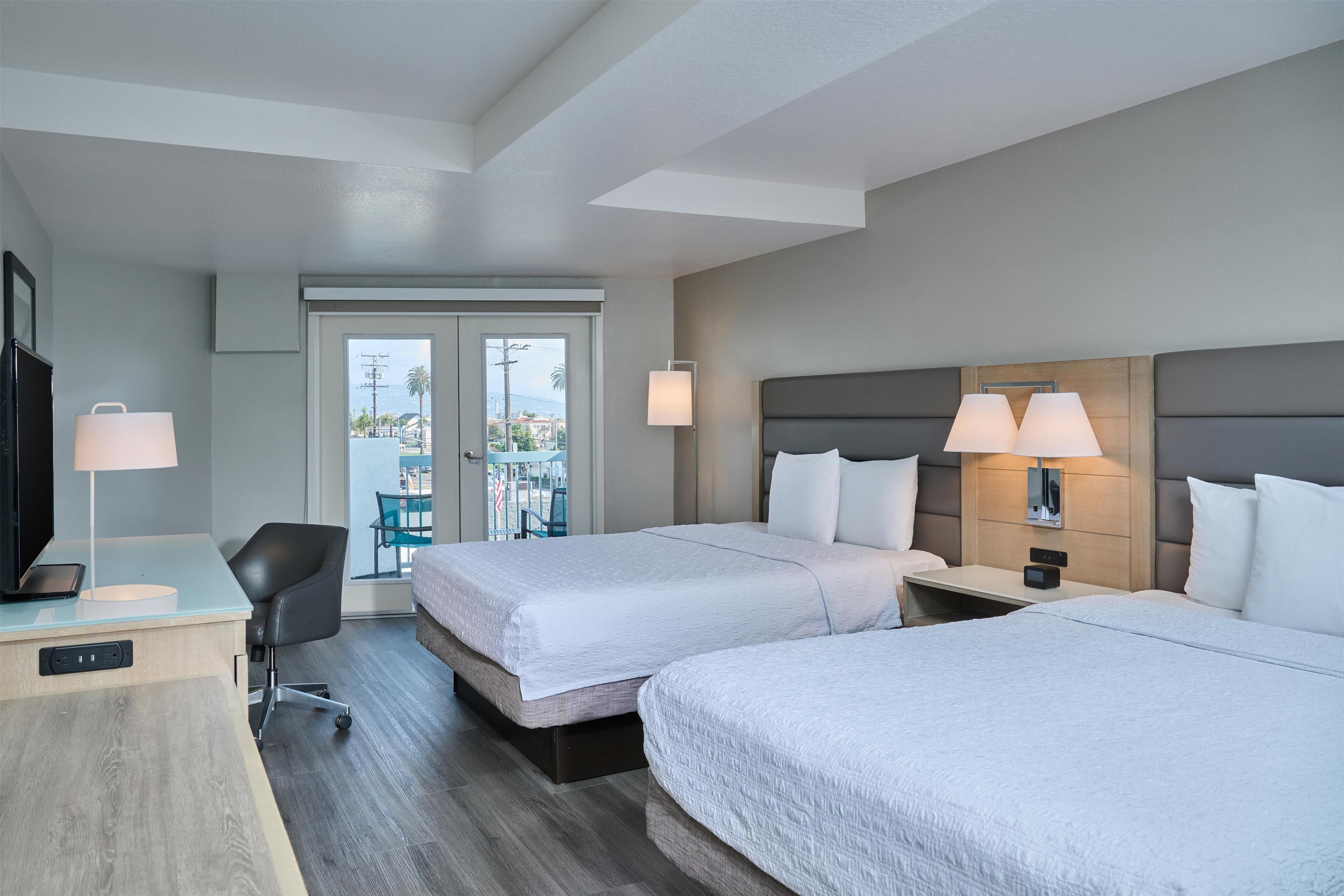 room, 2 queen beds, balcony | in-room safe, desk, iron/ironing board, free cots/infant beds