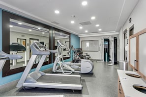 A modern gym with treadmills, elliptical machines, and free weights. - Hampton Inn Houston-Pearland (Pearland)