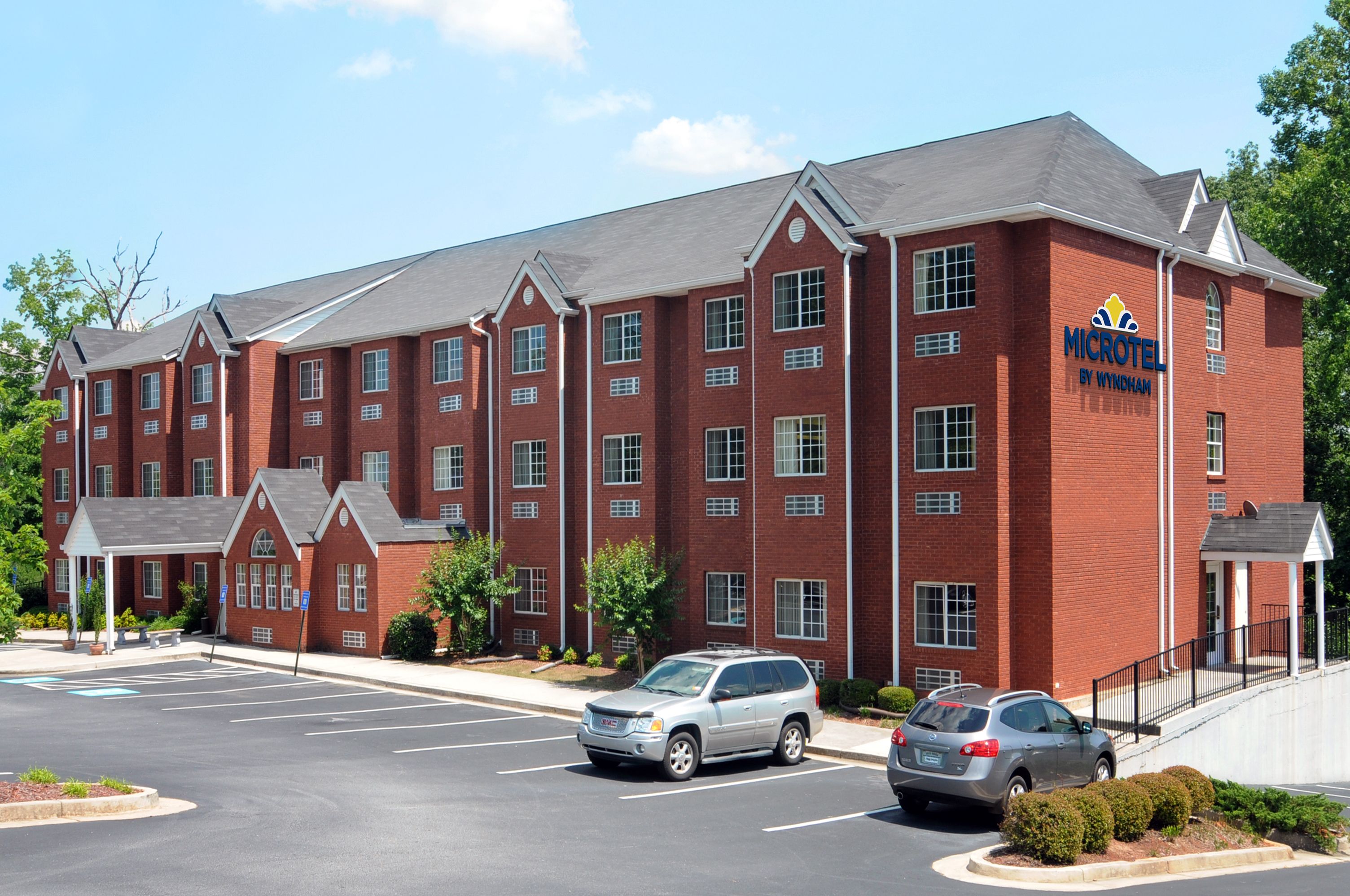 A red-brick hotel with a sign reading "MICROTEL BY WYNDHAM".