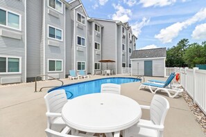 Outdoor pool, open 10:00 AM to 10:00 PM, pool umbrellas