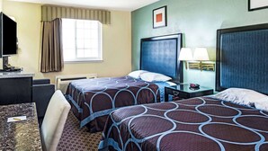 A hotel room with two beds, a desk, a chair, a TV, and a window with curtains. - Super 8 by Wyndham Sacramento/Florin Rd (Sacramento)