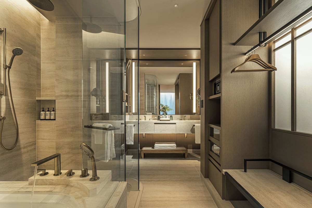 Une salle de bain moderne avec une douche à parois de verre, un meuble-lavabo avec un miroir et un banc en bois.