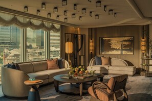 A modern hotel room with a large window, a sofa, a coffee table, and a painting on the wall. - Four Seasons Hotel Tokyo at Marunouchi (Tokyo)