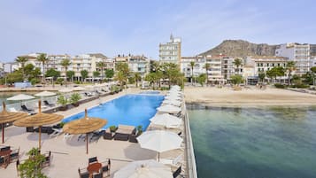 Enjoy a refreshing dip in the hotel's rooftop pool surrounded by lounge chairs and umbrellas.