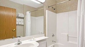 A bathroom with a sink, toilet, and bathtub.