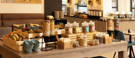 A buffet setup with various food items and containers.