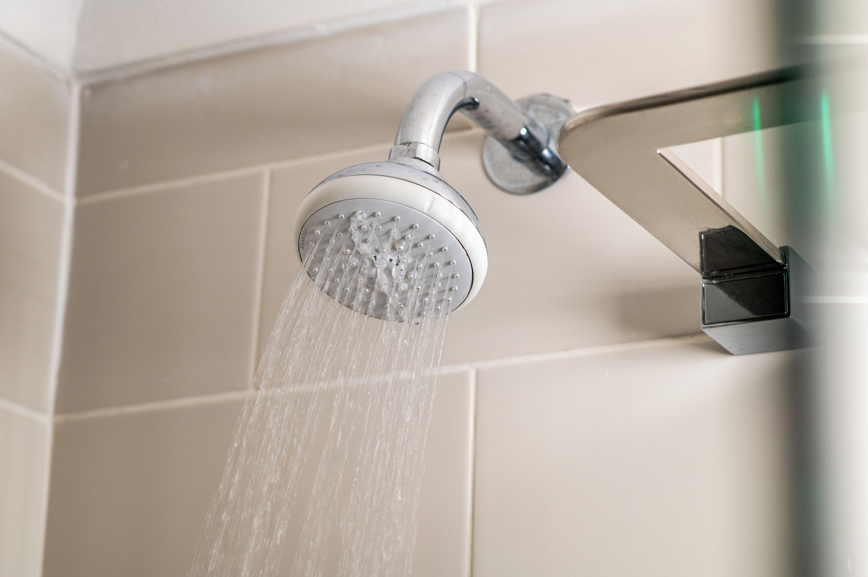 A showerhead with water flowing from it.