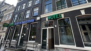 A hotel with a black facade, multiple windows, and a sign reading "HOTEL HEART OF AMSTERDAM". - Heart Of Amsterdam - Hostel (Amsterdam)