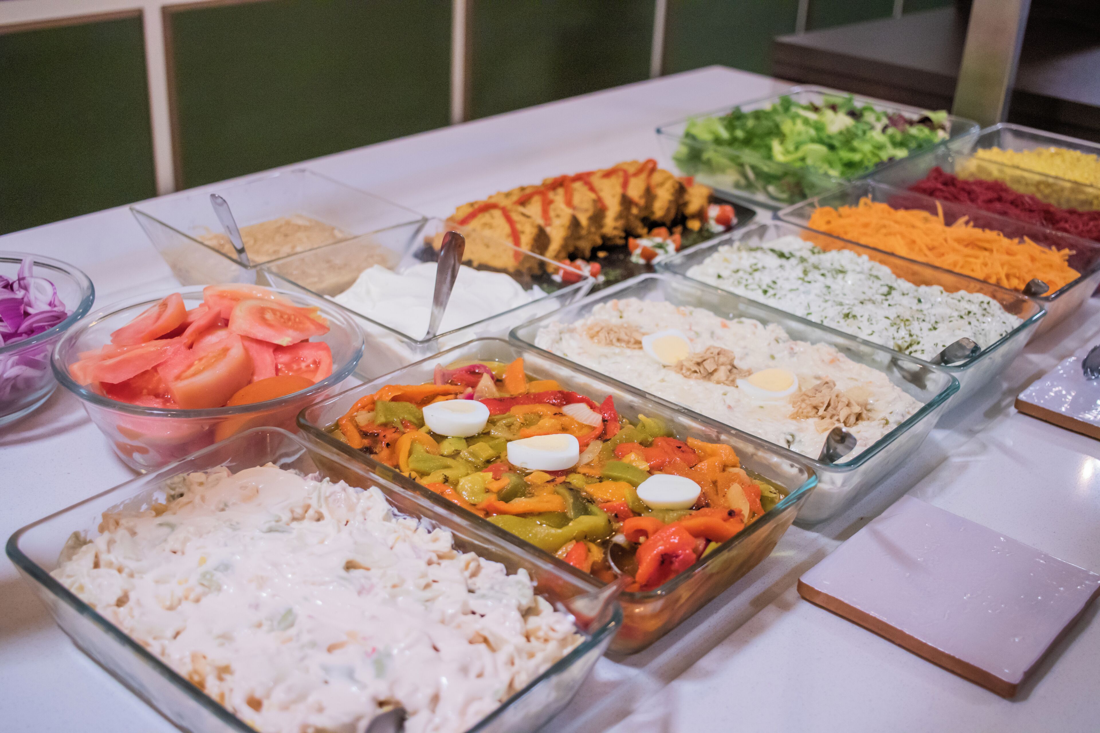 A buffet with various food options including salads, rice, and a variety of dishes.