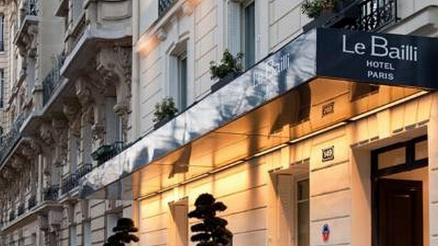 The exterior of Le Bailli Hotel in Paris, featuring a classic facade with large windows and a prominent entrance. - Hotel Bailli de Suffren (Paris)