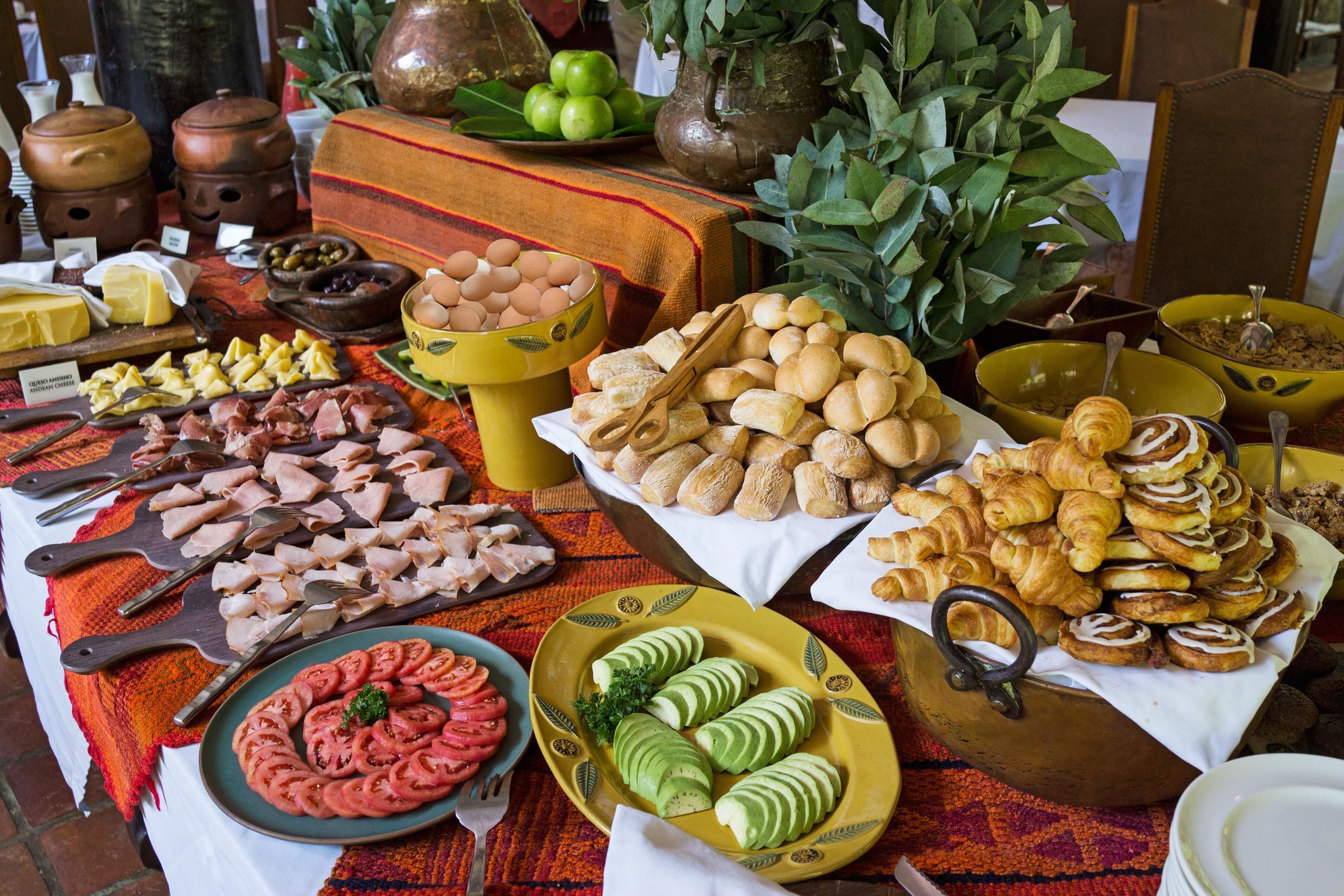 A table with various food items including meats, cheeses, and pastries.