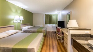 A hotel room with two beds, a desk with a chair, a television, and a bathroom with a sink. - Motel 6 Great Falls, MT (Great Falls)