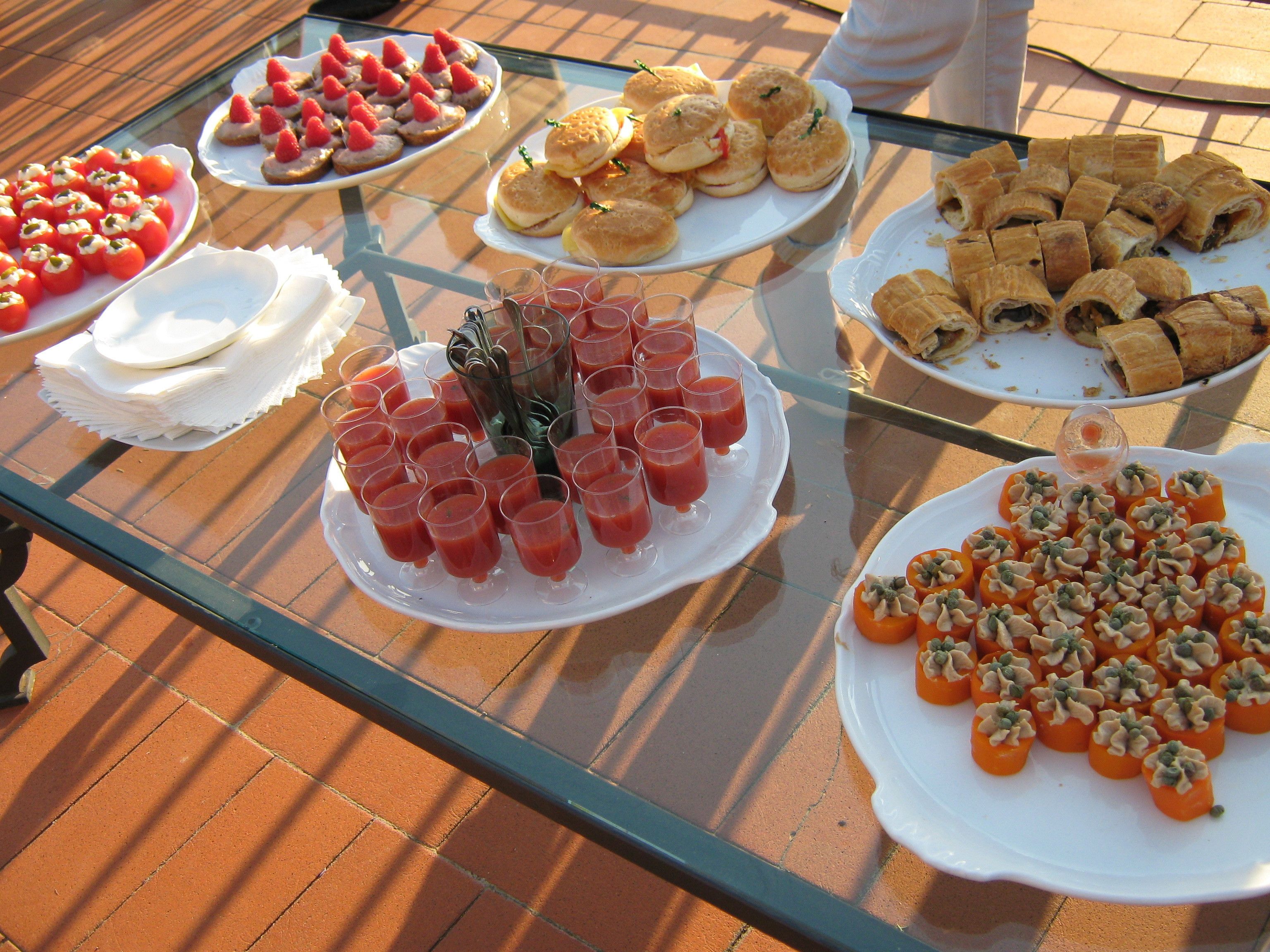 Taula de vidre amb diversos plats i begudes.