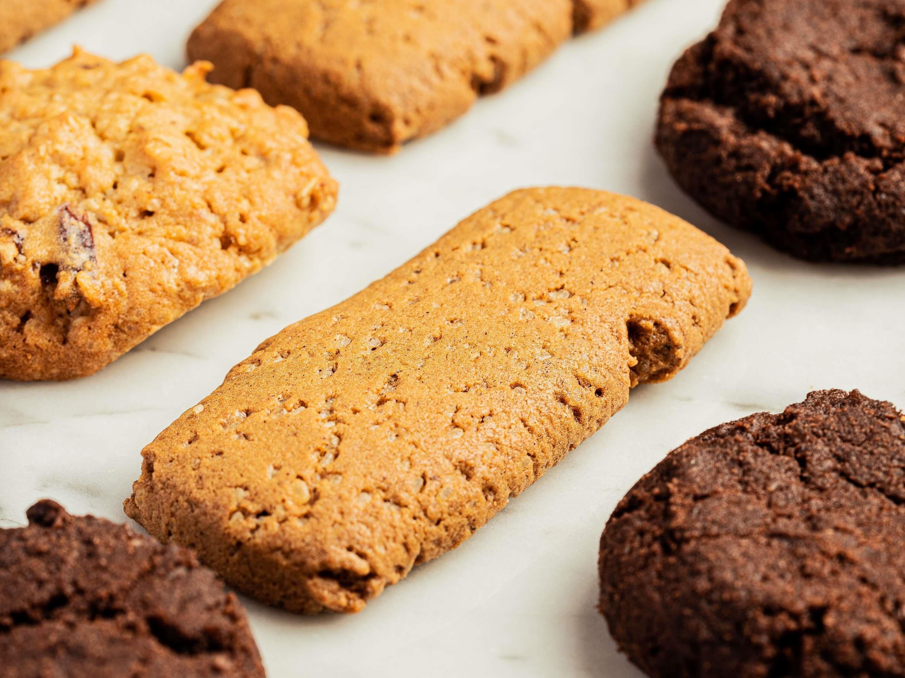 A variety of cookies on a marble surface.