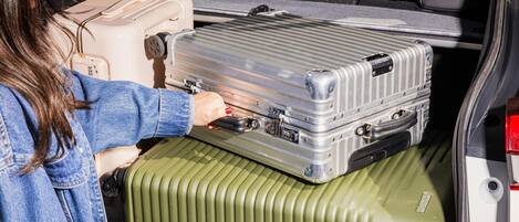 A vehicle interior with a person handling luggage.