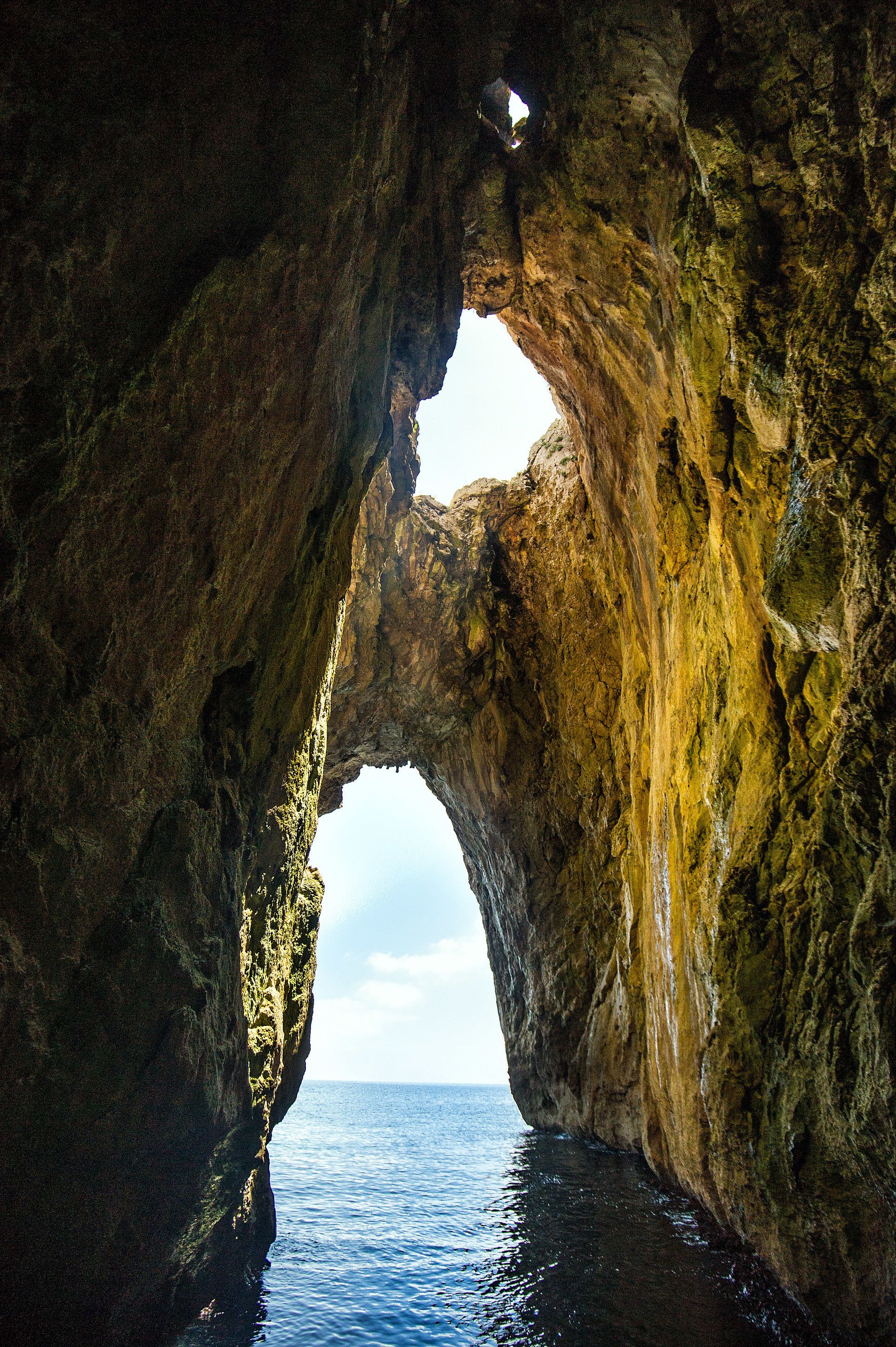 A natural rock formation with a cave-like opening.