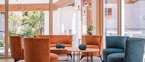 A modern interior with a sofa set, a table, and chairs.