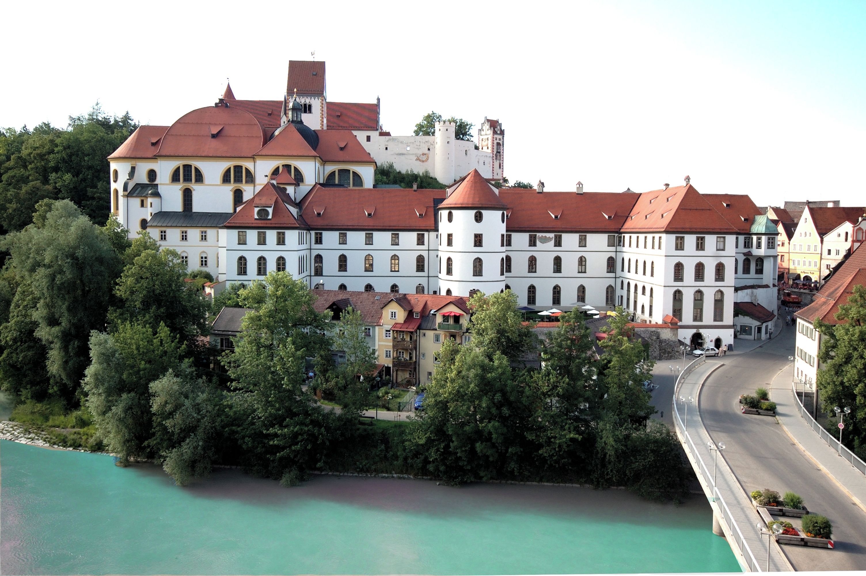 A historic building with multiple towers and a large courtyard.