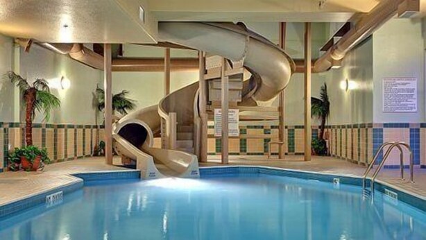 An indoor swimming pool with a spiral slide.