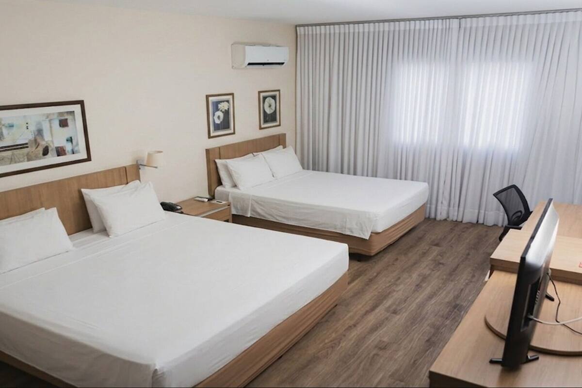 Family Room | Minibar, desk, WiFi (free), bed sheets