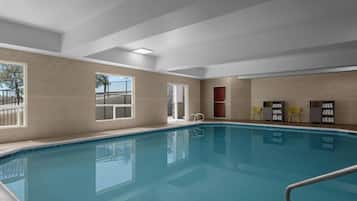 A swimming pool with a clear view of the surrounding walls and windows.