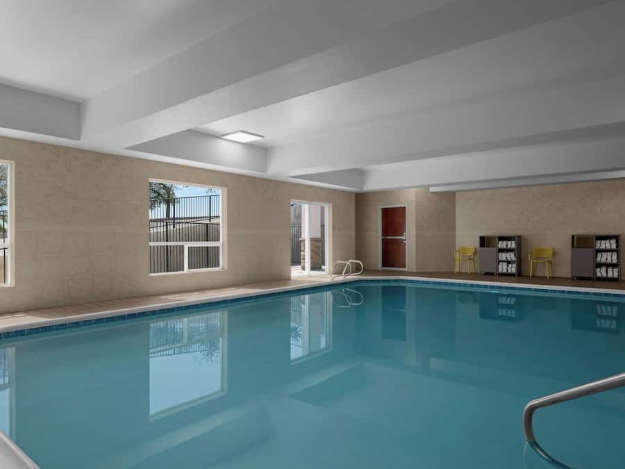 A swimming pool with a clear view of the surrounding walls and windows.