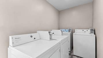 Un área de lavandería con lavadoras y secadoras Whirlpool.
