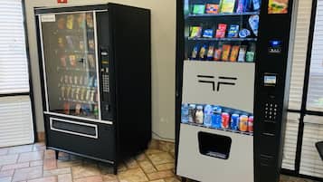 Two vending machines with a variety of snacks and drinks.