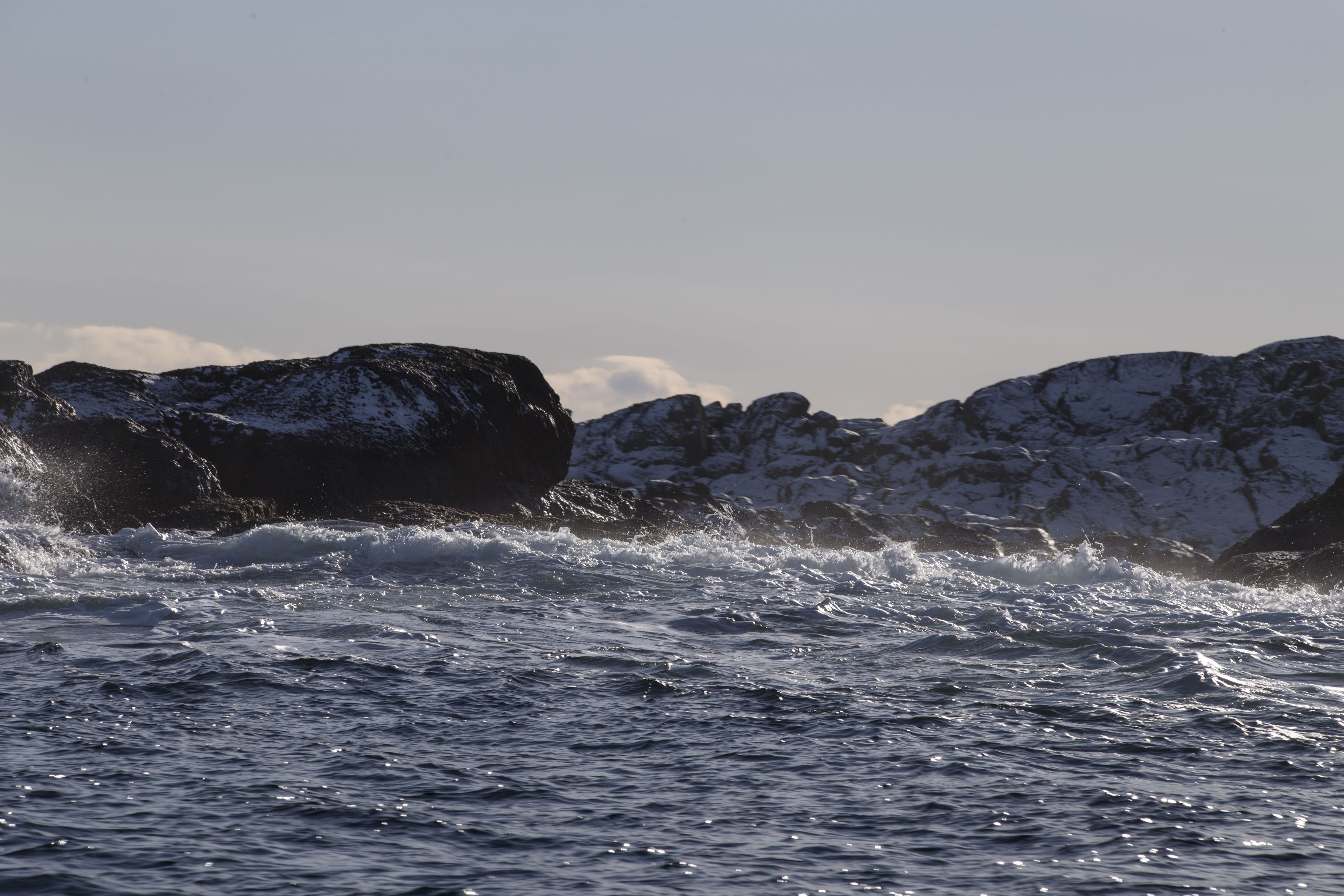A rocky coastline with waves crashing against the rocks.