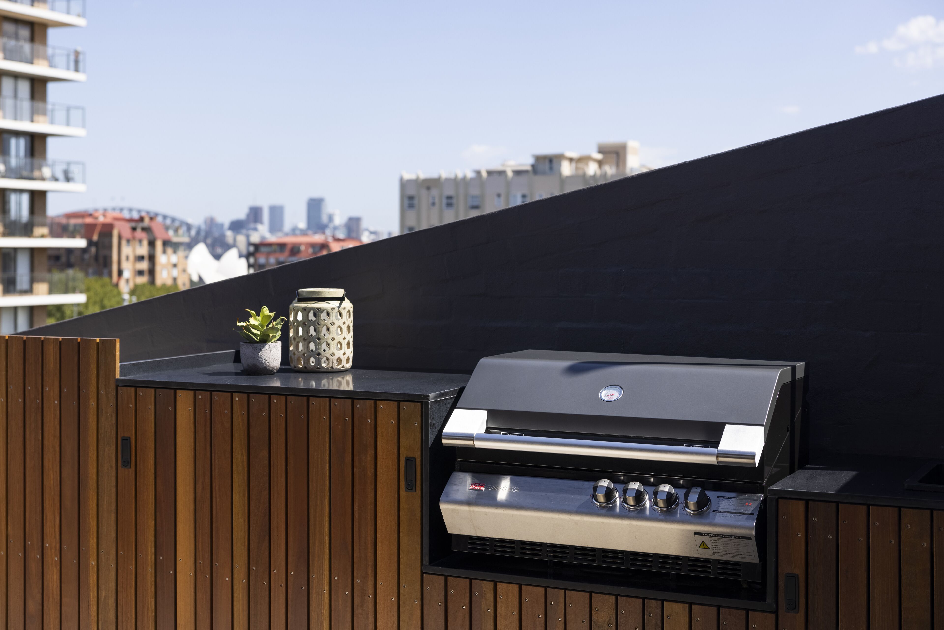A rooftop grill with a cityscape view.