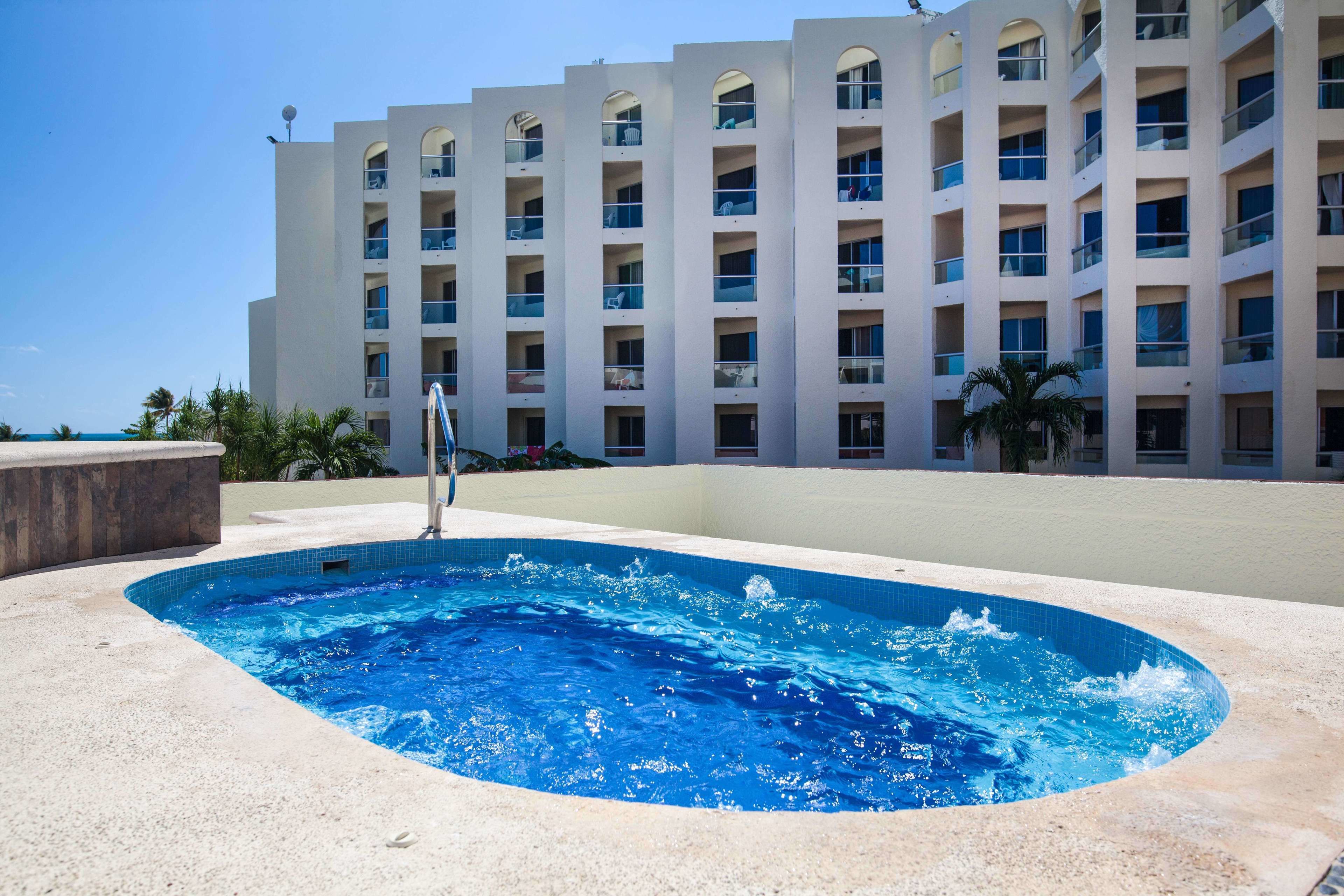 A swimming pool with a modern building in the background.