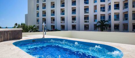 A swimming pool with a modern building in the background.