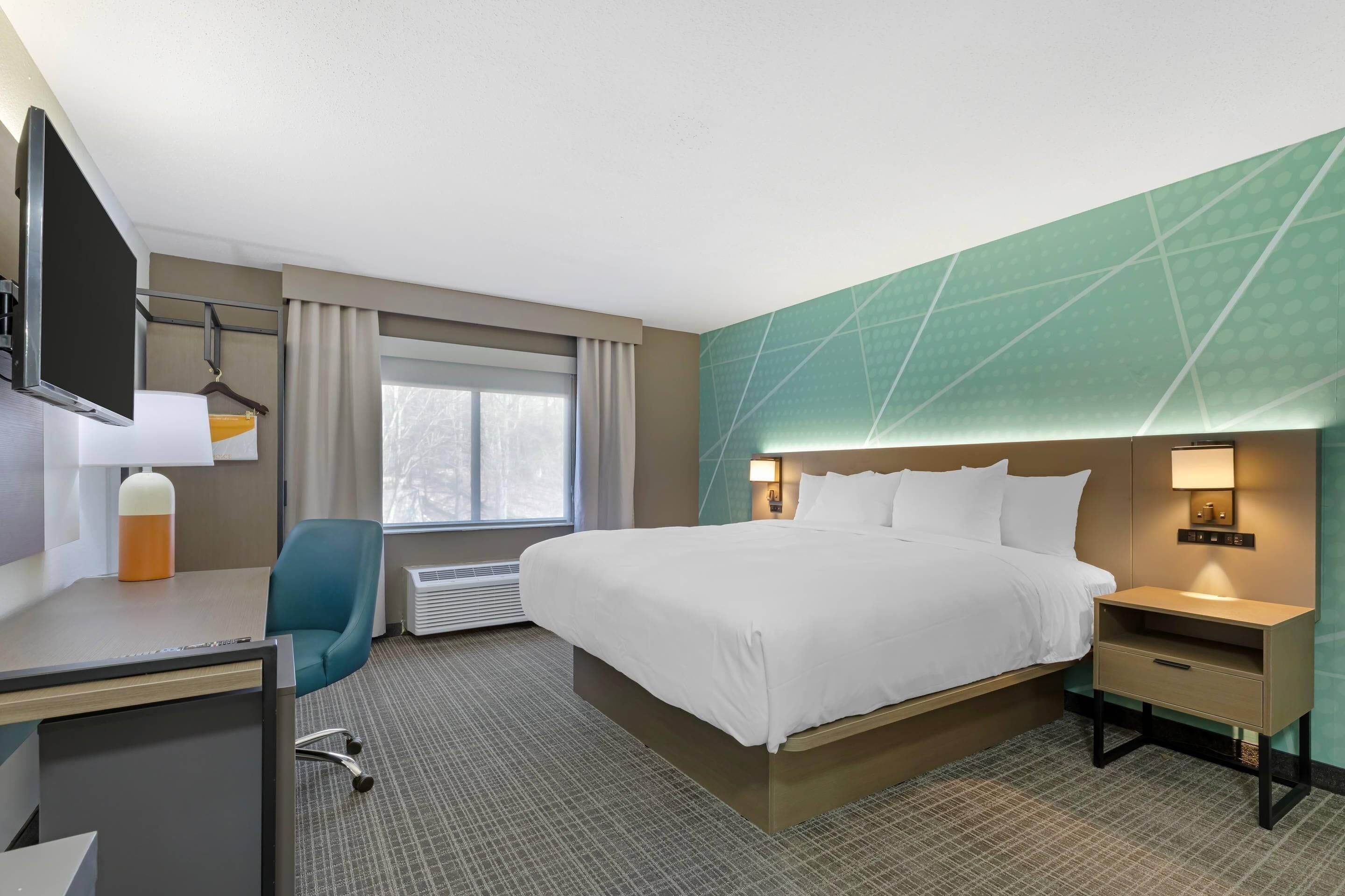 Suite, 1 King Bed, Non Smoking | Desk, laptop workspace, blackout curtains, iron/ironing board