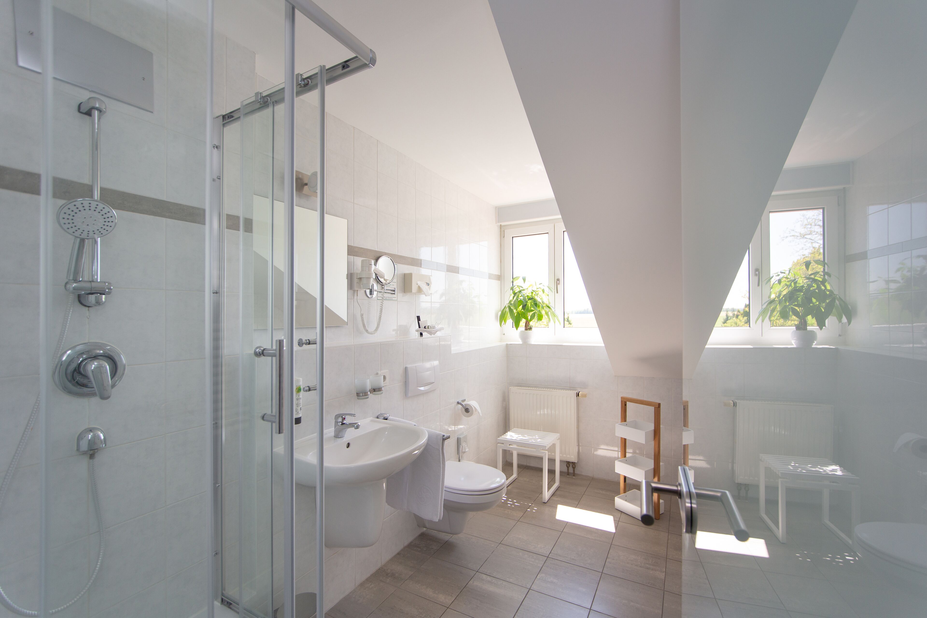 junior studio suite | bathroom | shower, free toiletries, hair dryer, bathrobes