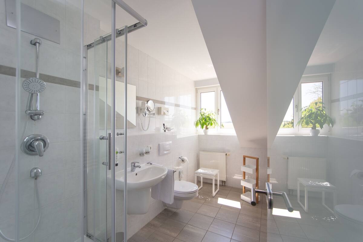 junior studio suite | bathroom | shower, free toiletries, hair dryer, bathrobes