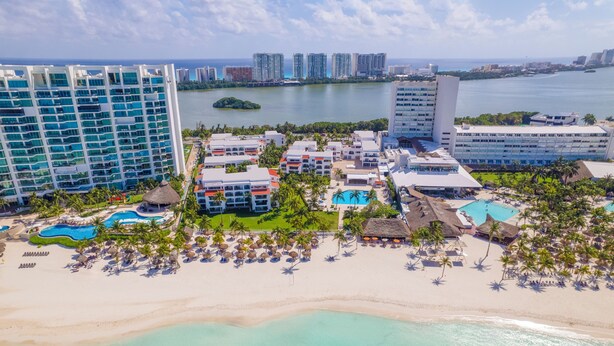A resort with multiple buildings, a beach, and a pool area. - Beachscape Kin ha Villas & Suites (Cancun)