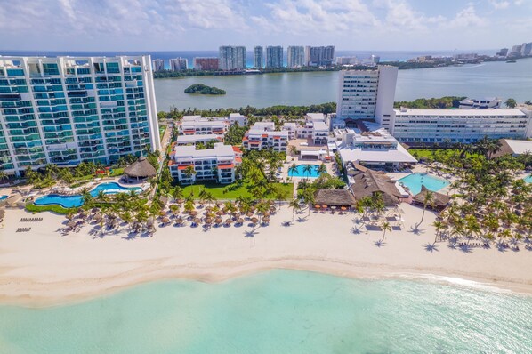 Enjoy expansive ocean views from the hotel's modern high-rise buildings, surrounded by lush greenery and palm trees.