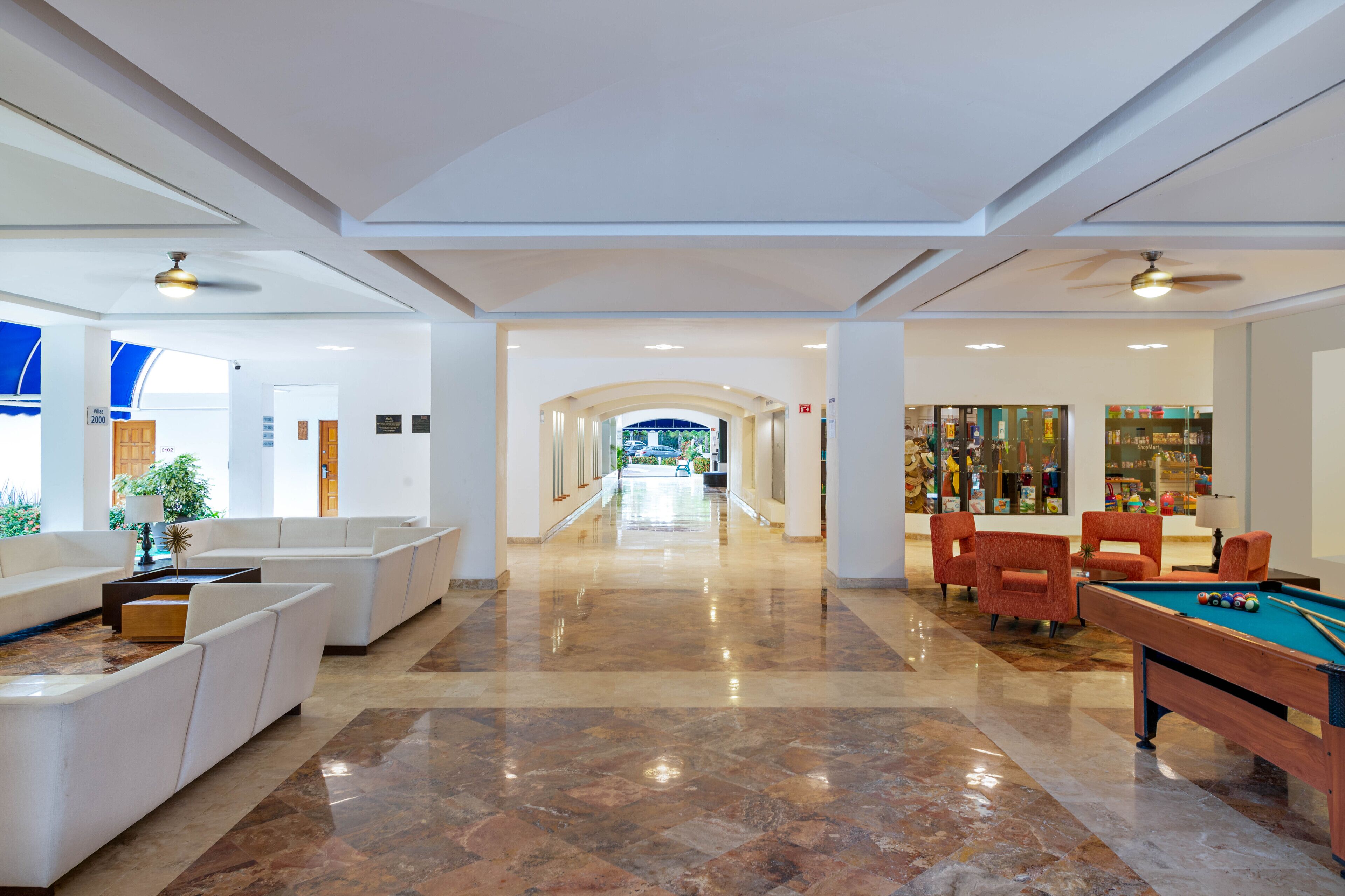 A spacious lobby with a billiards table, comfortable seating, and a clear view of the entrance.