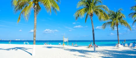 Private beach, white sand, sun loungers, beach umbrellas