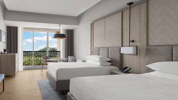 A modern hotel room with two beds, a balcony with a view, a desk, and a phone.